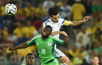 Micheal Babatunde battles it out with Emir Spahic during a World Cup game Photo Credit AFP