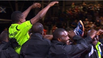 Nigeria's Ojo Onaolapo being lifted by teammates after beating India's Achanta in the deciding match to give Nigeria the bronze medal in the men's team event on Monday