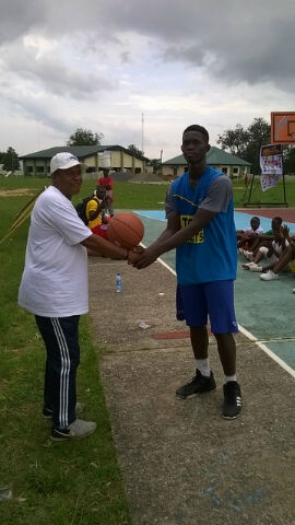 Christian Wisdom receives Ball from Akwa Ibom State Director of Sports Aniedi Dickson