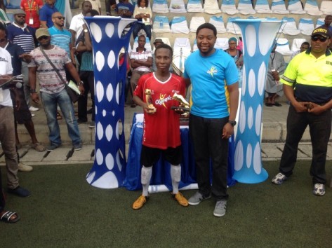 Kabiru Nasiru of De-Royals FC displays his Golden boot and MVP Awards with him his Mr Bamise Oyebami Brand Manager Olympic milk